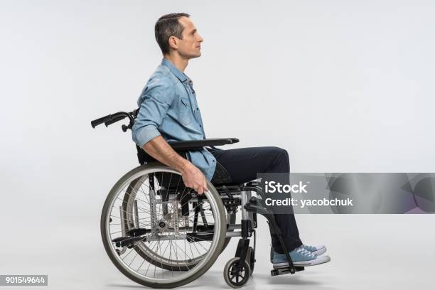 Handsome Physically Challenged Man Moving In Wheelchair Stock Photo - Download Image Now