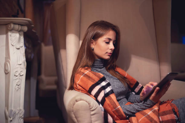 istock Skilled female trainee dressed casual clothes watching training webinar to improve skills and knowledge on modern touchpad sitting in cozy place, young charming hipster girl chatting in social network 901550158