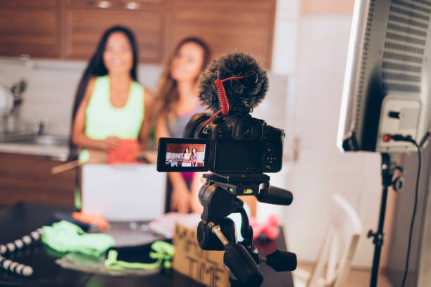 istock Female vloggers unpacking box with sportswear 901559678