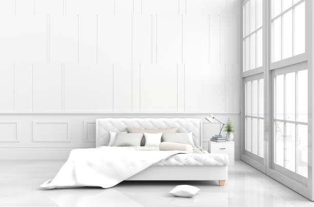 istock White bed room decor with tree in glass vase, pillows, white blanket, window, sky, lamp,bookcase,white wall it is pattern,The sun shines through the window into the shadows,White floor. 3d render. 901560282