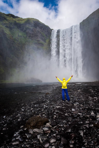 istock Woman in front of waterfall 901562568