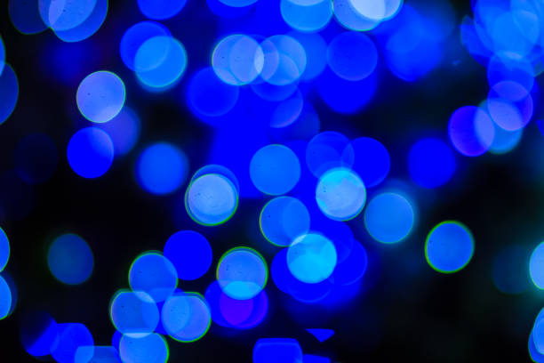 istock Beautiful blue bokeh abstract light background. Wonderful Defocused abstract blue christmas background. Abstract christmas lights as background in the night with noise grain and poor light. 901563482