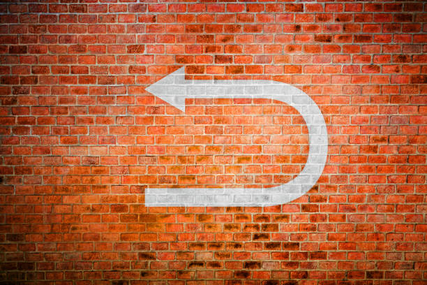 Decision making White turnaround sign on vintage brick wall dipping stock pictures, royalty-free photos & images