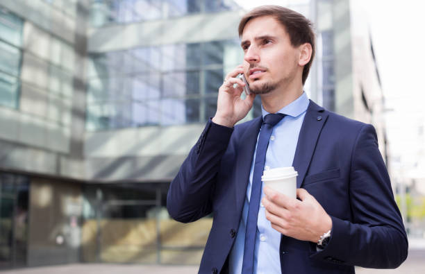 istock Businessman talking on the phone with coffee 901566474
