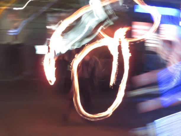 istock Dancer with flaming fire pois after dark. 901567246