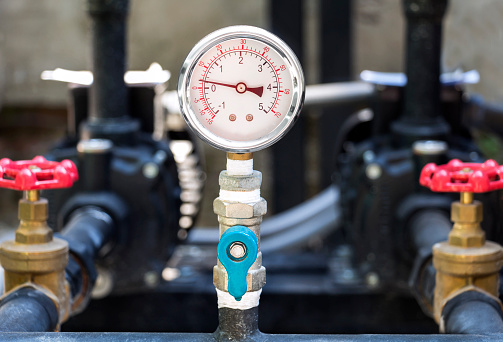 Closeup of manometer (pressure gauge). Chrome pipes and valves with measuring gas pressure on oil and gas pipeline at industrial.