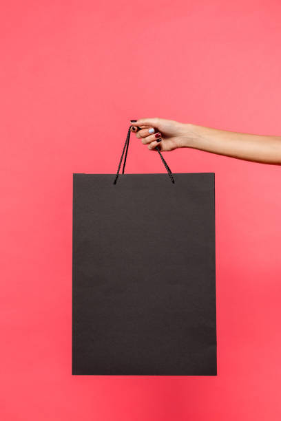 istock person holding shopping bag 901568238