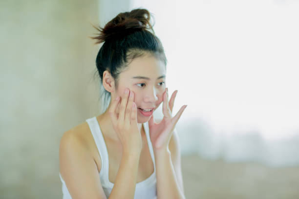 istock Young woman massaging her face 901568424