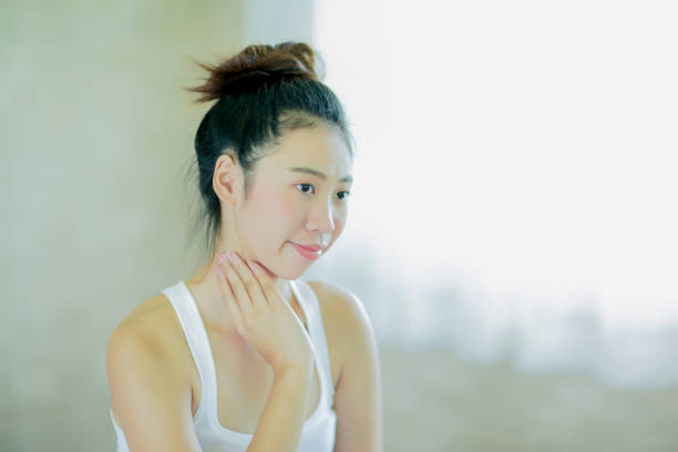 istock Young asian woman massaging her neck 901568436