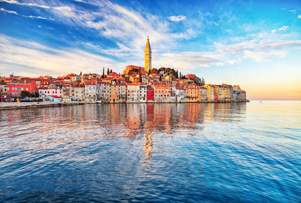 Morning view of old town Rovinj, Croatia View of old town Rovinj with reflections on calm sea. rovinj harbor stock pictures, royalty-free photos & images