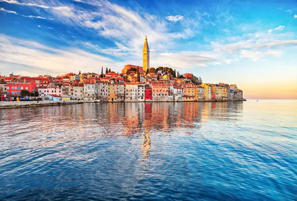 View of old town Rovinj with reflections on calm sea.