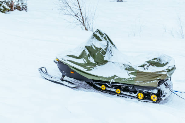 istock snowmobile covered by snow nobody near it 901571752