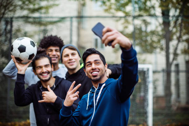 Smiling players taking selfie through mobile phone