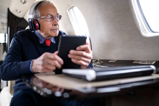 istock Businessman in private jet airplane 901574602