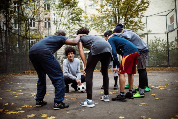 istock Captain discussing with team huddling on street 901574638