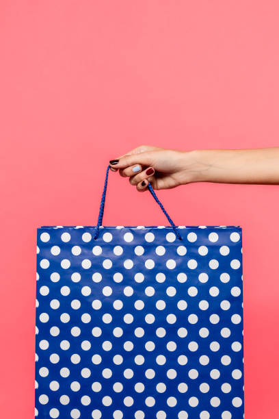 istock person holding shopping bag 901574798