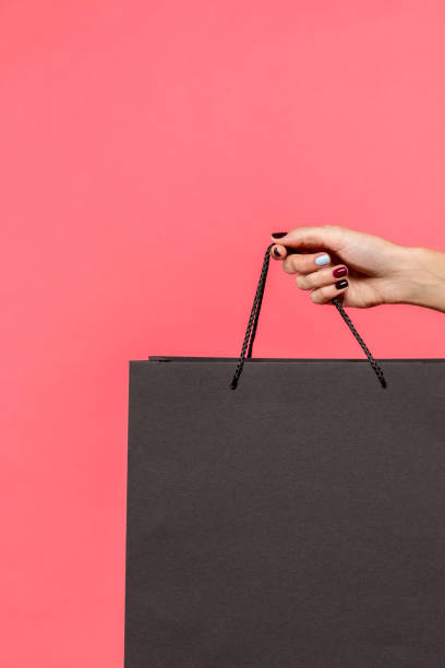 istock person holding shopping bag 901575616
