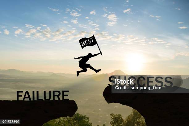 Men Jump Over Silhouette Hand Hold Flag Best Failure Committed To Success Stock Photo - Download Image Now