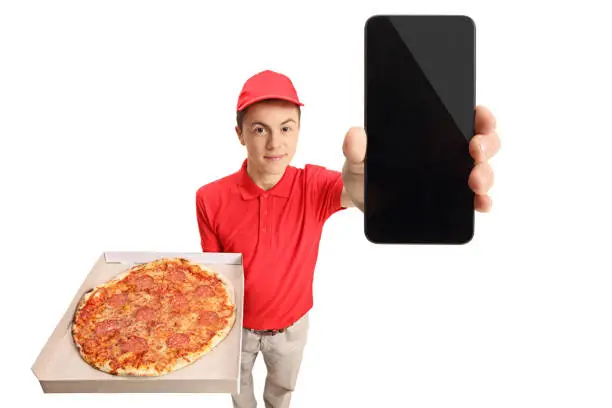 Photo of Teenage pizza delivery boy showing a phone