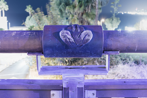 Tel Aviv-Yafo, Israel, December 01, 2017 : Sign of the zodiac Virgo on the bridge of the Wishing Bridge in the violet light of a spotlight located on old city Yafo in Tel Aviv-Yafo in Israel