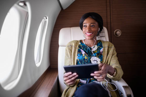 istock Woman in private jet airplane 901579014