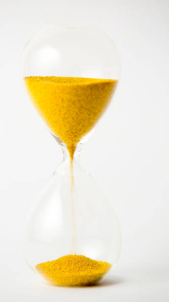 istock hourglass with gold beads on white background 901580164