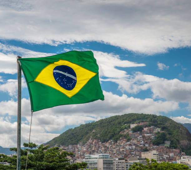 istock Brazilian flag and favela background 901580484
