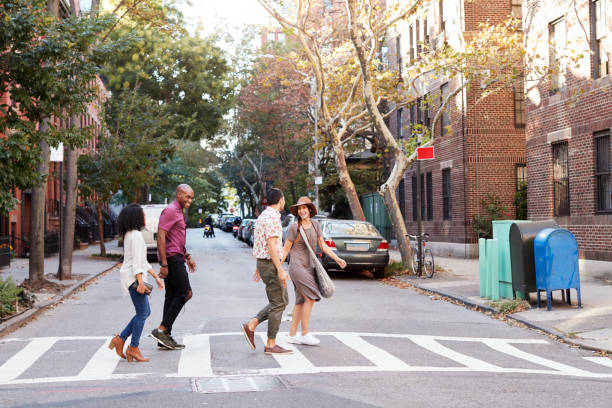 group of friends crossing urban street in new york city - front stoop imagens e fotografias de stock
