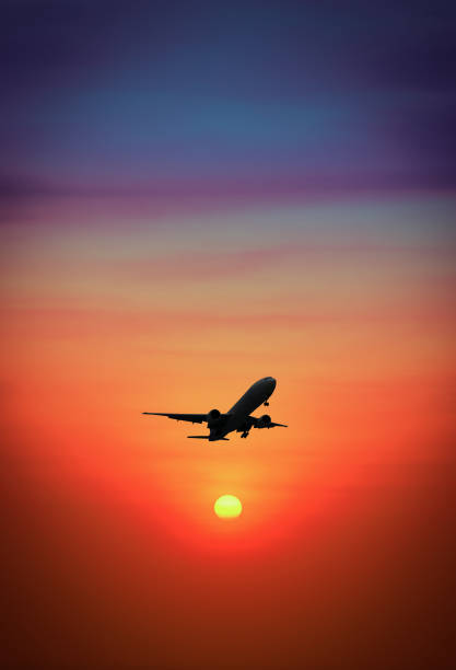 istock Silhouette plane flying above mountain at during sunset. 901584802