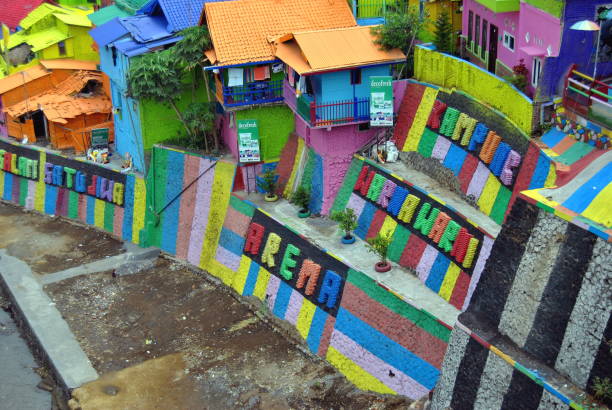 Colorful houses in Kampung Warna Warni Jodipan in the city of Malang, on East Jawa, Indonesia. A slum village on the slope of a river bank that turned into a tourist attraction after a project to make houses and buildings more colorful and creating an enjoyable environment.