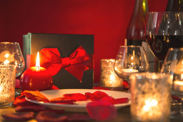 istock Valentine's Day romantic candlelight dinner with gift and wine. 901592098