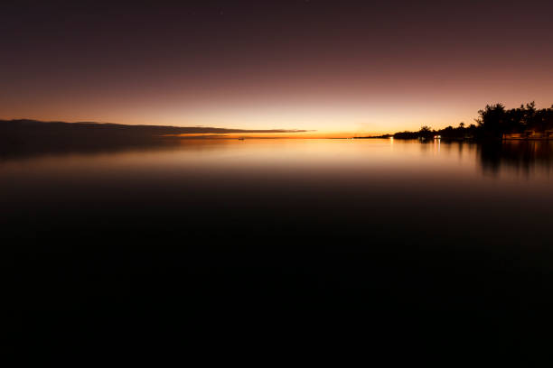 Bright stars on black sky over an illuminated Noosa.