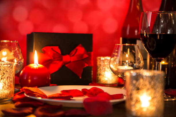 istock Valentine's Day romantic candlelight dinner with gift and wine. 901595680