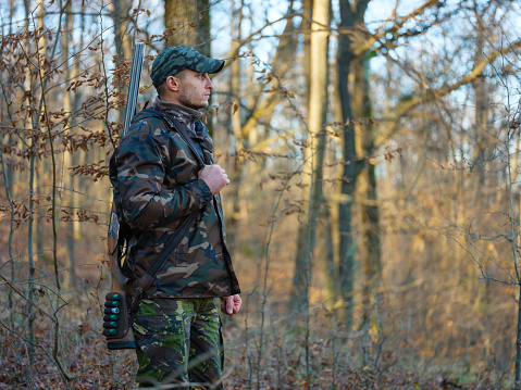Hunter in camo suit with double barrel shotgun