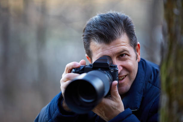 istock Photographer with camera outdoor 901598570