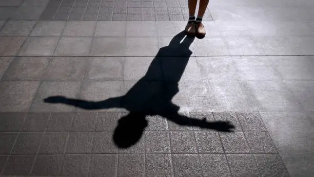 Shadow of A Child Standing and Spreading His Arms