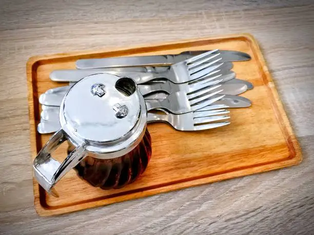 Honey for Topping Dessert in Small Jug with Forks and Knives