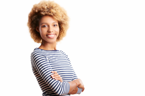 Shot of a laughing young afro-american woman standing against at isolated white background with copy space.
