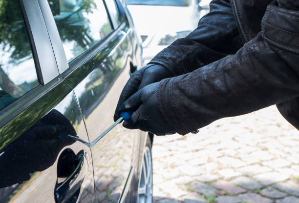 istock A burglar breaks a vehicle with a screwdriver 901602092