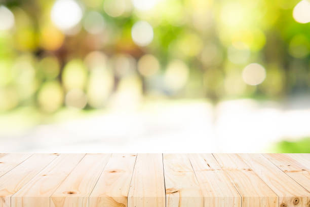 istock Wood table top on green nature background 901608726