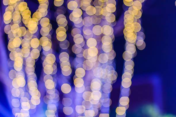 istock Beautiful blue bokeh abstract light background. Wonderful Defocused abstract blue christmas background. Abstract christmas lights as background in the night with noise grain and poor light. 901610192