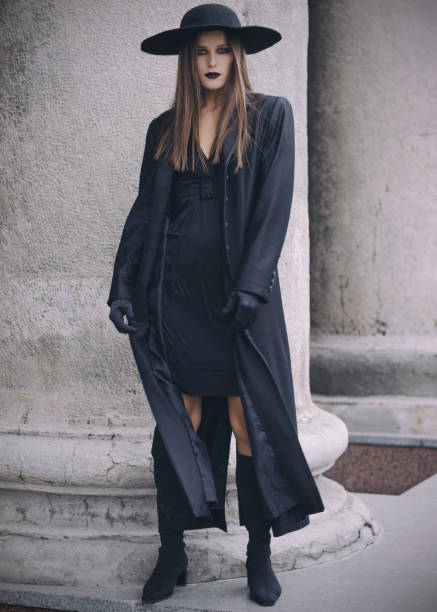 istock Beautiful gitl in black coat wearing black hat and balck gloves 901612752
