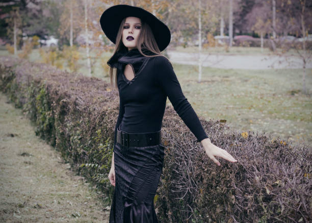 istock Beautiful girl wearing big black hat 901612814