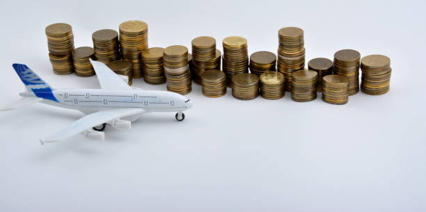 istock Plane plastic toy with coins isolated on white background 901613022