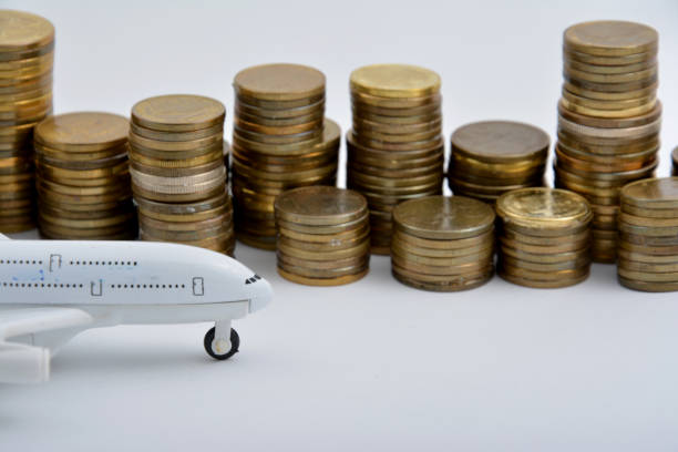 istock Plane plastic toy with coins isolated on white background 901613120