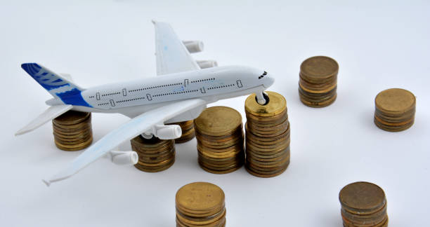 istock Plane plastic toy with coins isolated on white background 901613122