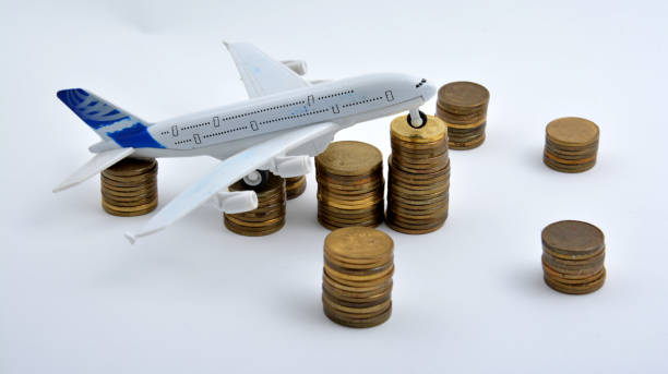 istock Plane plastic toy with coins isolated on white background 901613216