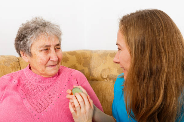 istock Happy elderly woman and young caregiver 901613236