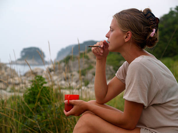 istock girl on the beach with coffee and cigarette 90161689
