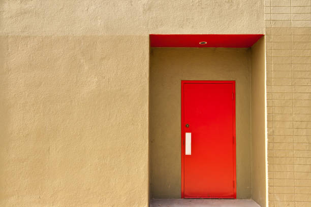istock Red door on yellow building exterior. 901617458